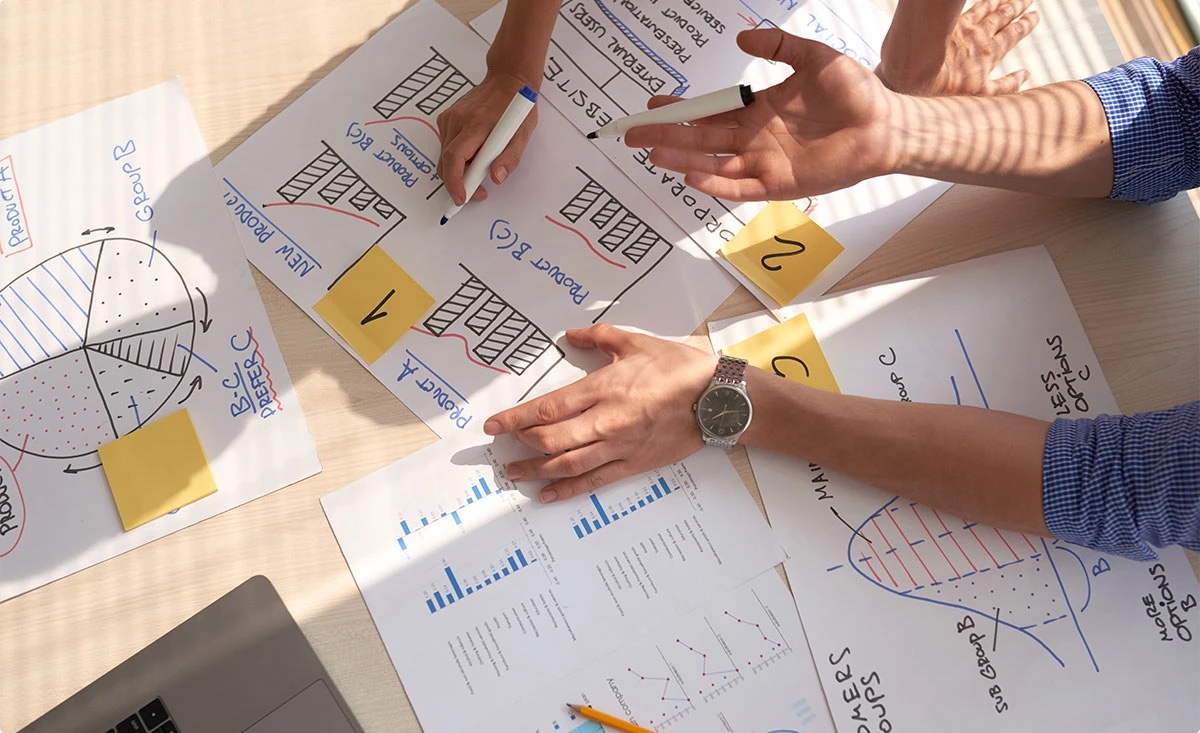 Team planning a product with charts and sketches
